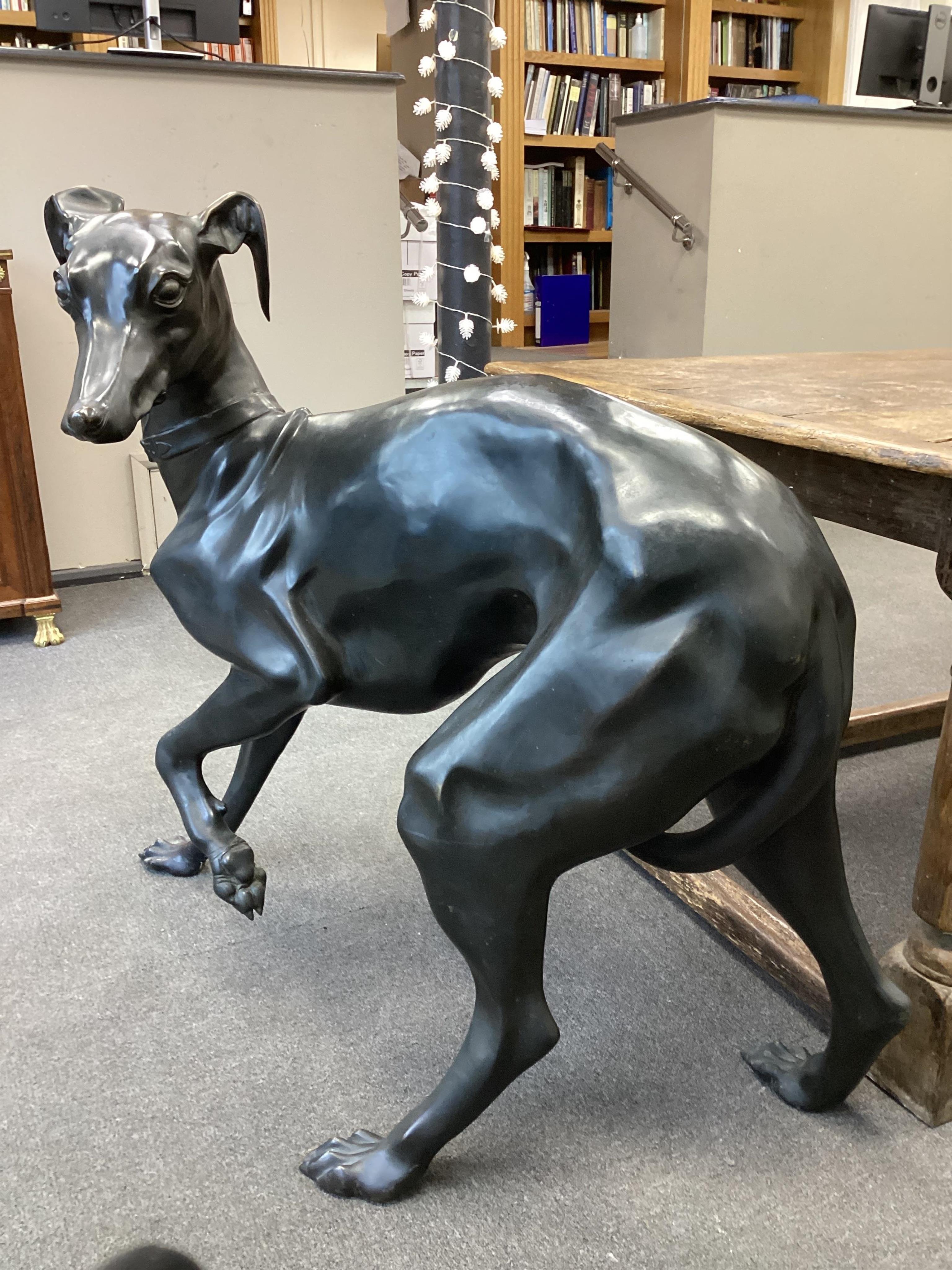 After P.J.Mene a life size dark patinated bronze of a standing greyhound, length 115cm, height 97cm. Condition - good